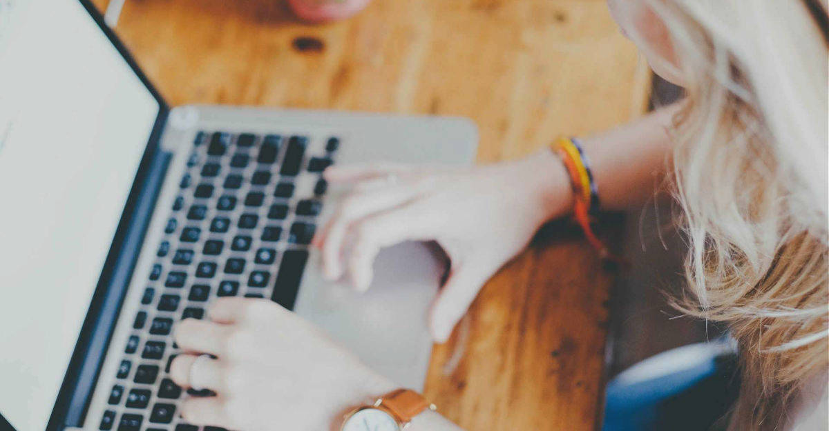 Woman Typing on Laptop